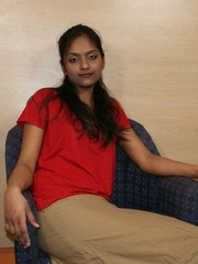 Amazing ponytailed indian girl in a red t-shirt and beige skirt
