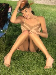Ponytailed indian babe undressing and posing outdoor