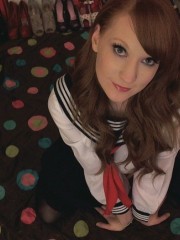 Redhead busty schoolgil in sexy uniform pulls down her white panties to show her shaved pussy.